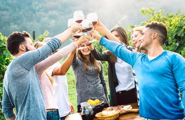 Fototapeten Happy friends drinking wine at taste experience  - Young people toasting at winery vineyard © Mirko Vitali
