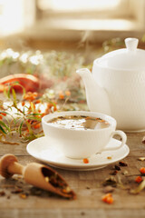 sea buckthorn tea white porcelain on a wooden background