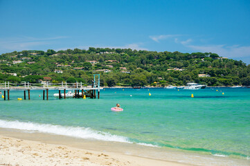 Crystal clear blue water of legendary Pampelonne beach near Saint-Tropez, summer vacation on white sandy beaches of French Riviera, France