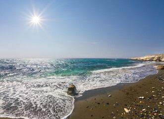 stony emerald sea coast at sunny day