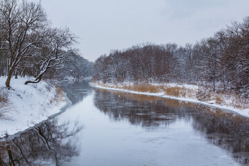 quiet river among snowbound forest, winter natural landscape