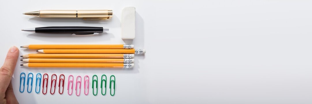 Person Arranging The Pencils On White Background