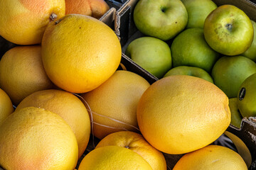 Fresh Tropical Grapefruit And Apples On A Market Sellers Stall
