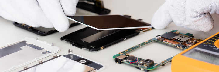 Person Fixing Damaged Screen On Mobile Phone