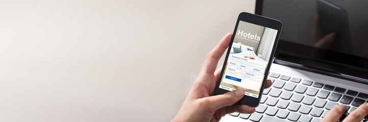 Person Booking Hotels Using Cell Phone