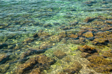 Fototapeta na wymiar Shallow sea with rocks and clear blue water.