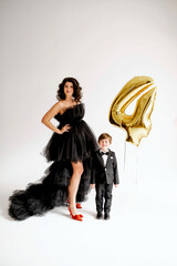 Woman at dress with son at suit