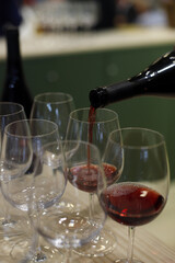 llenando copas de cristal con vino tinto