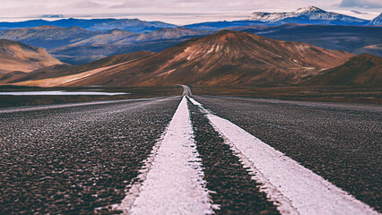 a road leads to the high mountains of landmannalaugar in iceland