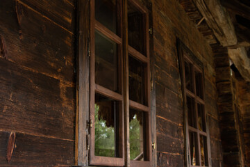 Wooden old house with windows in Ukraine, the window