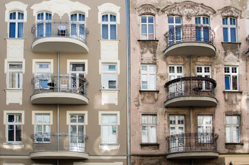 Apartment building on Cybulskiego street. The facade of half of the house after repair and the second half of the facade is not repaired