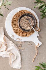Peeled sunflower seeds in a ceramic bowl with a spoon in kitchen countertop. For healthy food and diet concepts. Top view