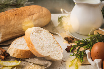 Ingredients for preparing spanish torrijas, french toasts  or traditional Portuguese rabanadas for Christmas. Typical sweet food for Christmas made with slices of bread, eggs, cinnamon, milk, lemon