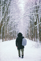 Bearded man in the winter woods. Attractive happy young man with beard walk in the park.