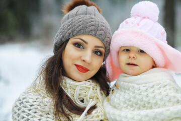 Happy family playing and laughing in winter outdoors in the snow. City park winter day.