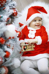 Merry bright christmas. Lovely baby enjoy christmas. Childhood memories. Santa girl little child celebrate christmas at home. Family holiday. Girl cute child cheerful mood play near christmas tree.