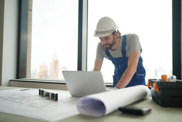 Architect and construction engineer or surveyor discussion plans and blueprints