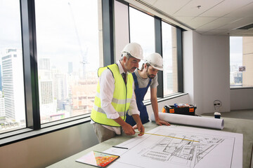 Architect and construction engineer or surveyor discussion plans and blueprints