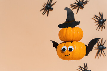 Decoration for Halloween kids party - flying cute pumpkin head with eyes and funny face. Pumpkin monster, witch, vampire, crawling spiders. Copy space, promotion. Halloween banner. Levitation.