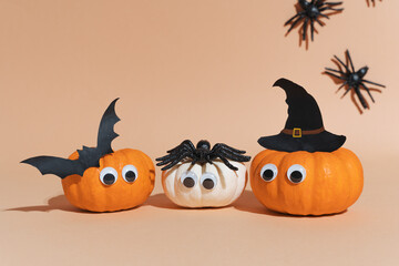 Decoration for Halloween party - cute pumpkin heads with eyes and good faces. Witch hat, flying bat and spiders. Not scary Halloween decoration. Art activity for kids, diy master class.