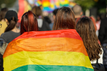 Shallow depth of field (selective focus) with people attending a LGBTQ rights protest.