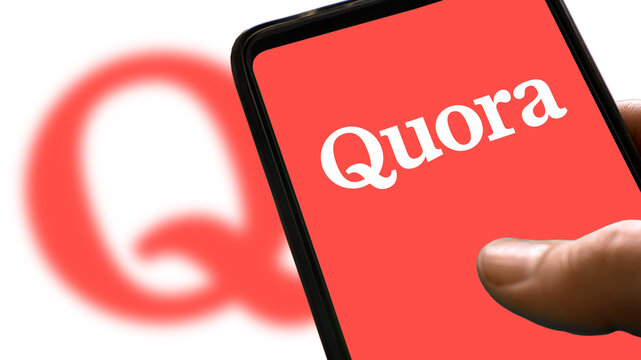 Red Quora Logo On A Smartphone Screen With Icon On Background And Blur Word