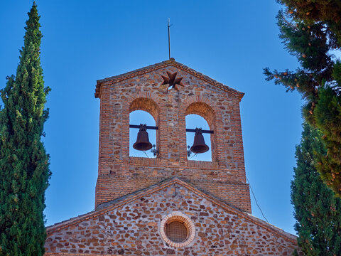 Stone and brick bell tower with two bells of the church  Parroquia de Nuestra Señora del Buen Consejo y San Anton. Puerto Lapice, village in the route of Don Quixote, province of Ciudad Real, Spain