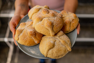 Traditional  mexican bread of the dead and cup of coffee on a bread tray