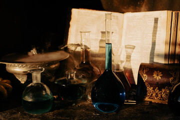 Smoking cauldron, magic potions and ancient spell book