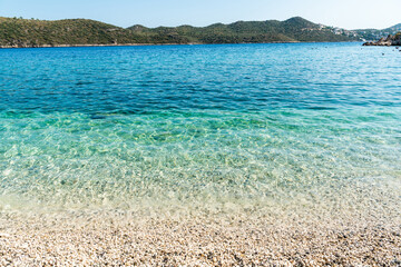 Waters of the Mediterranean sea on Akcagerme pebble beach near Kas resort town in Antalya province of Turkey