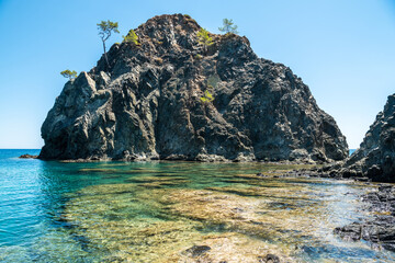 Small rocky islet adjacent to the main land in Cirali hamlet of Antalya province in Turkey.