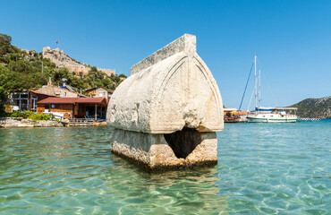 Semi-submerged Lycian sarcophagus tomb by the shore of Kalekoy village of the Demre district in the Antalya Province of Turkey.