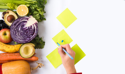 Woman counting calories for healthy food preparation. Lifestyle and proper nutrition. Top view grocery banner