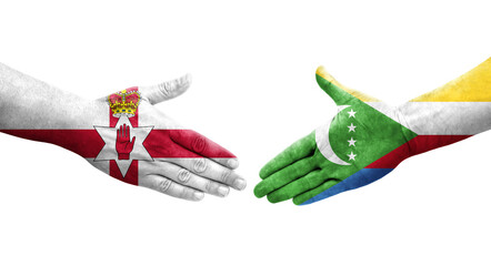 Handshake between Comoros and Northern Ireland flags painted on hands, isolated transparent image.