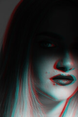Fashion and make-up concept. Beautiful blonde woman portrait partly face covered with shadow ir red and blue color split effect. Futuristic looking style. Mouth and nose illuminated with light