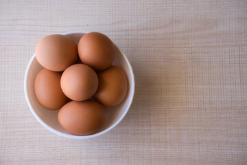 Fresh eggs on wooden table.