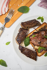 Food photo fried beef liver with bacon and basil