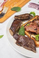 Food photo fried beef liver with bacon and basil