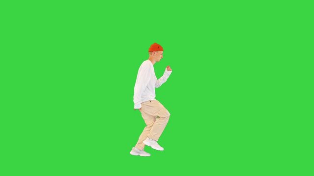 Cool young breakdancer walking and dancing on a Green Screen, Chroma Key.