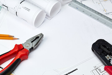 Working tools and drawings of the designer on a white background. Construction of houses, drawing, interior design.