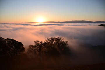 Fototapeta premium sunrise over the clouds
