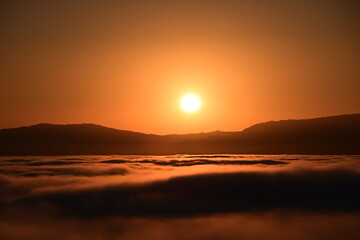 Obraz premium sunrise over the clouds