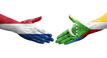 Handshake between Comoros and Netherlands flags painted on hands, isolated transparent image.