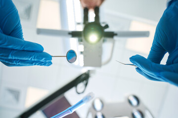 Experienced dentist using modern diagnostic equipment during patient examination
