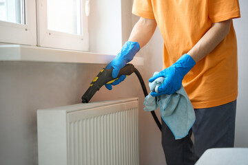 Close up photo of lady cleaning heaters