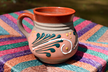 Cup of coffee on colorful background