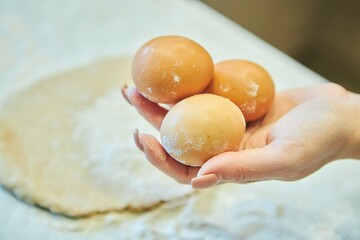Fresh chicken eggs in a woman's hand. Baking preparation.