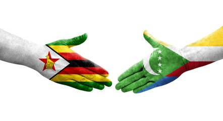 Handshake between Comoros and Zimbabwe flags painted on hands, isolated transparent image.