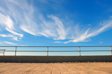Metal barrier or railings between promenade and blue sky