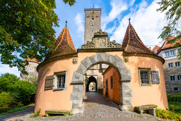 The Western town gate Burgtor in the picturesque medieval German town of Rothenburg ob der Tauber, Germany, one of the stops along the Romantic Road of Bavaria.